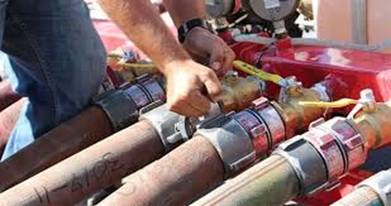 Técnico conectando mangueiras de incêndio à bancada para o teste hidrostático